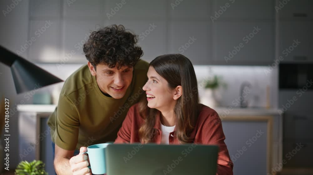 Amazed friends talking virtual call looking computer screen at kitchen closeup Amazed friends talking virtual call looking computer screen at kitchen closeup