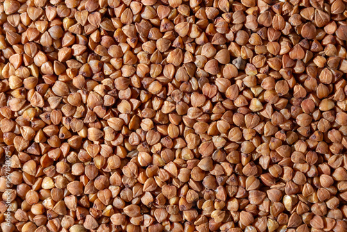 Dry Uncooked Brown Buckwheat Groats Background - Top View, Flat Lay. Raw Large Buckwheat Grains. Russian, Ukrainian and Belarusian Culture