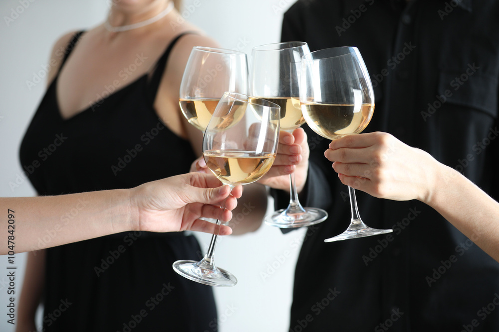 People clinking glasses of wine indoors, closeup People clinking glasses of wine indoors, closeup
