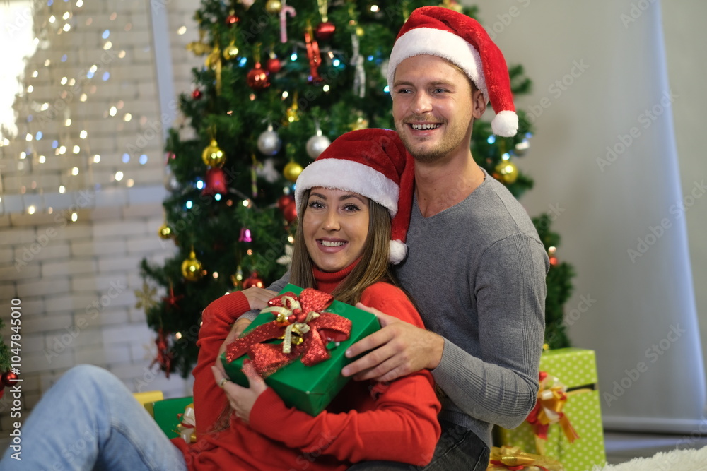 Caucasian lover, couple man and woman open gift box to celebrate Christmas together with decorated Christmas tree. Merry Christmas and Happy Holidays. Christmas holiday celebration and happy new year. Caucasian lover, couple man and woman open gift box to celebrate Christmas together with decorated Christmas tree. Merry Christmas and Happy Holidays. Christmas holiday celebration and happy new year.