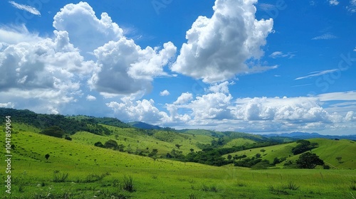 Rolling Green Hills with Lush Vegetation Under a Cloudy Blue Sky