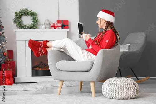 Young woman in santa hat an...