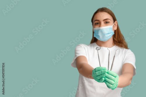 Female dentist in mask with...