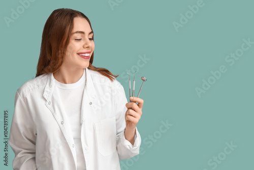 Female dentist with dental tools on blue background. World Dentist Day