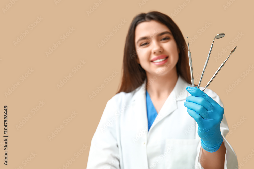 Female dentist with tools on brown background. World Dentist Day Female dentist with tools on brown background. World Dentist Day