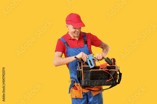 Young male electrician with...