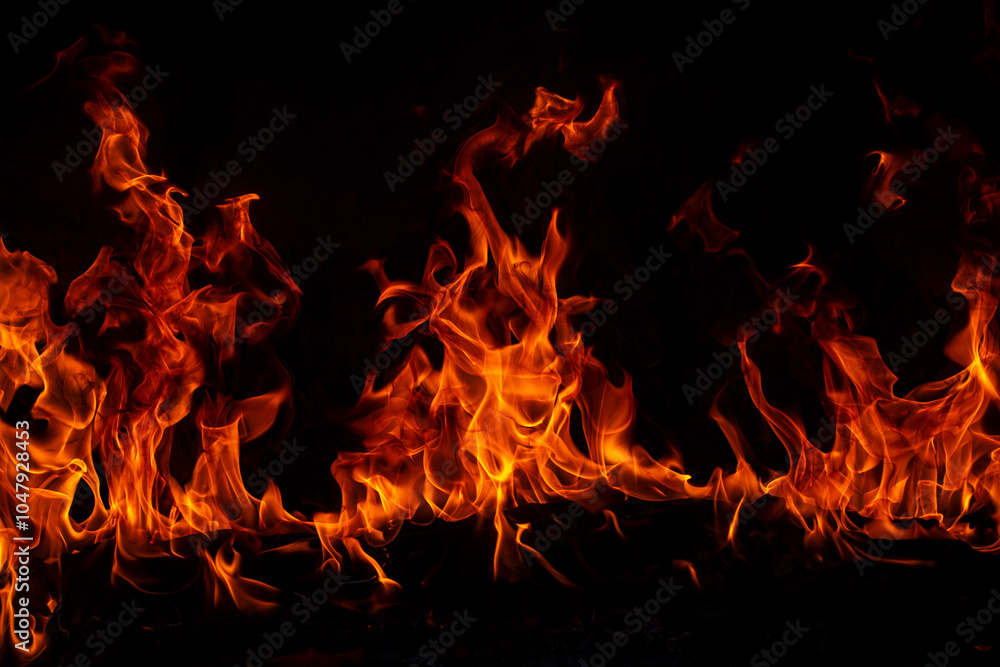 Fototapeta premium Fire flames on black background. Fire burn flame isolated, abstract texture. Flaming effect with burning fire.