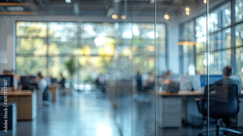 Modern office, long floor to ceiling windows, busy company staff