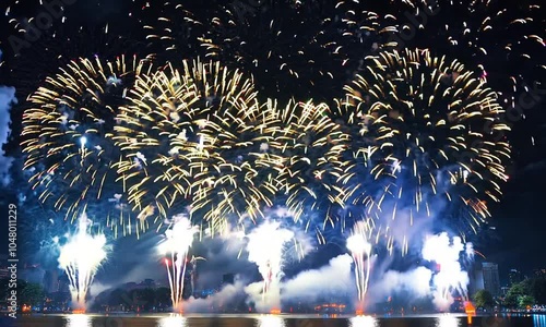 Wallpaper Mural A vibrant display of fireworks lighting up the night sky over a body of water. Torontodigital.ca