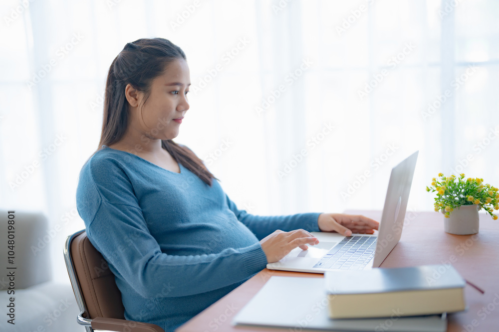 Pregnant asian woman using laptop at home pregnant businesswoman typing on laptop working on remote project in home office pregnancy concept Pregnant asian woman using laptop at home pregnant businesswoman typing on laptop working on remote project in home office pregnancy concept