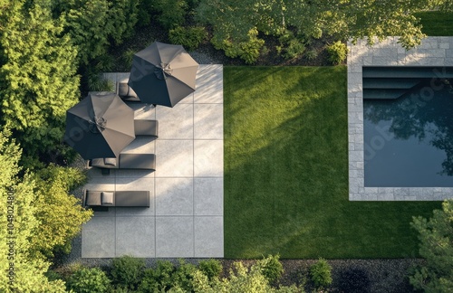 The backyard of an elegan home with a lawn, patio area, and pool in the background photo