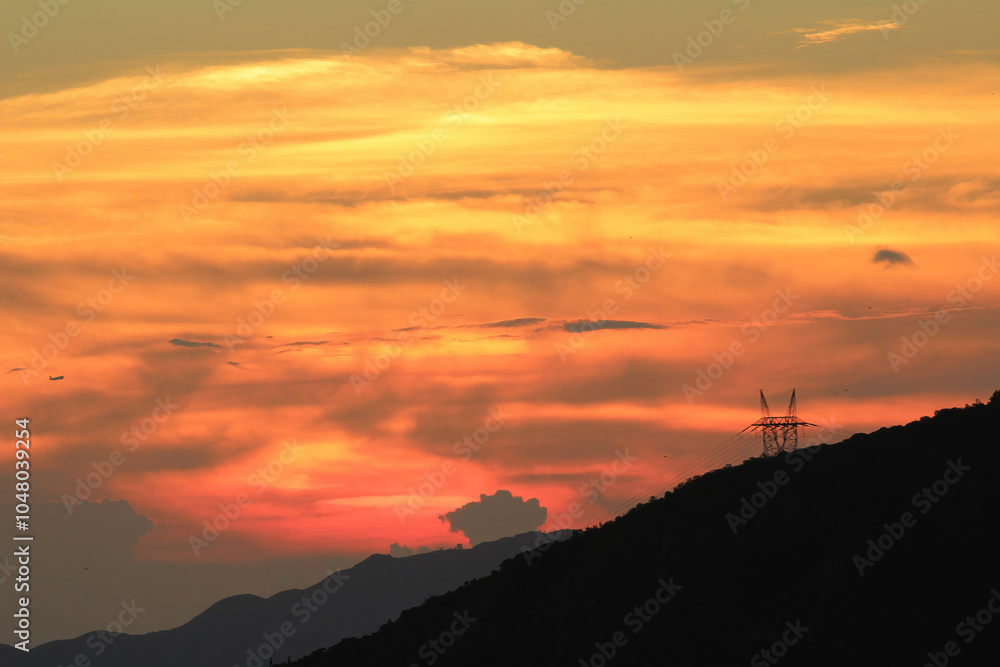 Fototapeta premium Orange And Yellow Colors Sunset Sky. Sunlight through clouds