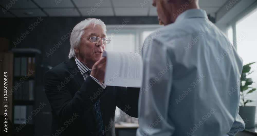 In modern office: Angry boss having fight with male company employee over unsuccessful business deal. Senior team leader with papers loses temper, yells. International corporation or bank. Slow Motion In modern office: Angry boss having fight with male company employee over unsuccessful business deal. Senior team leader with papers loses temper, yells. International corporation or bank. Slow Motion