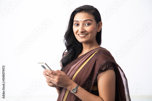 Smart Wife Looking At Camera While Holding Mobile Phone In Hand
