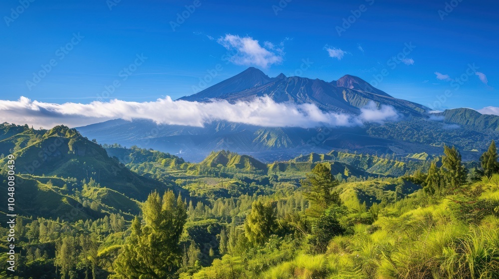 Obraz premium Lush Green Hills and a Majestic Volcanic Peak under a Clear Blue Sky