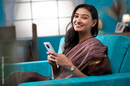 Hot Mature Wife Smiling While Looking At Camera With Cell Phone
