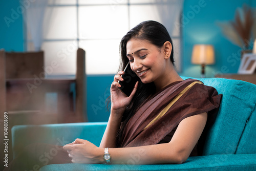 Pretty Housewife Smiling While Talking On Mobile Phone
