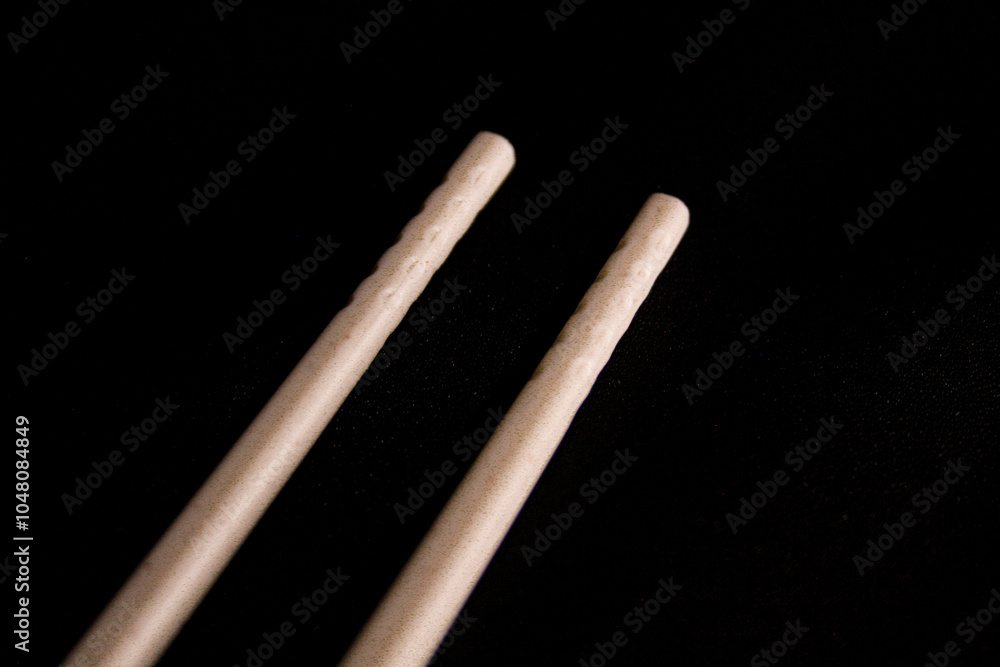 Pair of plastic chopsticks on black background Pair of plastic chopsticks on black background