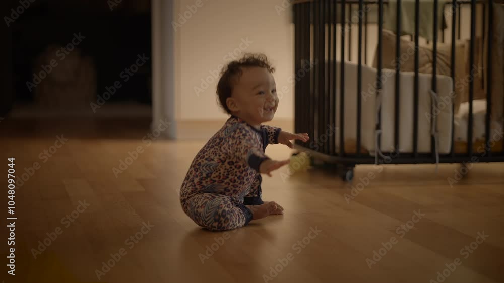 An adorable child is sitting on the floor in a cozy home environment filled with warmth