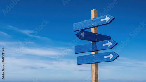 A wooden signpost with multiple blue arrows pointing in different directions against a clear blue sky.