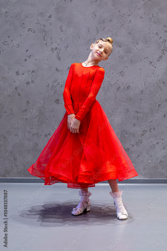 happy girl dancing in a bright red dance dress on a gray background ...