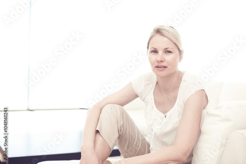 Portrait, house and woman on couch, relax and comfortable with weekend break in living room. Face, person and girl on sofa, casual outfit and resting with morning routine, calming and peaceful