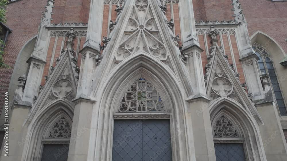 Carved stone entrance of the Holy Trinity Church in Krakow, showcasing its Gothic architecture and historic exterior Carved stone entrance of the Holy Trinity Church in Krakow, showcasing its Gothic architecture and historic exterior