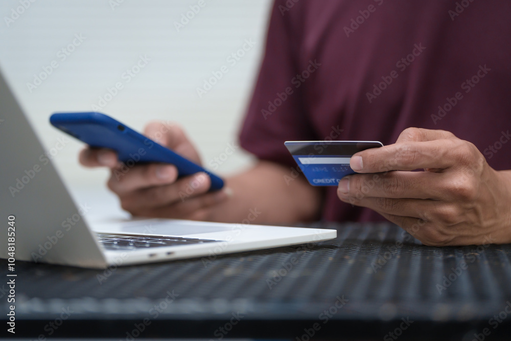 Close-up of a man's hand holding a bank credit card, highlighting online services for lending and access to credit,demonstrating financial convenience and flexibility for secure digital transactions Close-up of a man's hand holding a bank credit card, highlighting online services for lending and access to credit,demonstrating financial convenience and flexibility for secure digital transactions