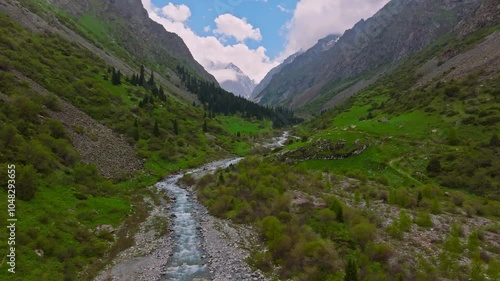 Ala Archa National Park at summer day in Kyrgyzstan, aerial view with pedestal up camera movement. photo