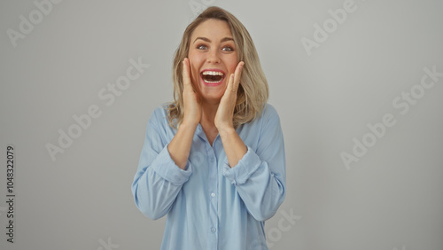 A cheerful caucasian woman wearing a blue shirt expressing excitement, isolated on a white background.