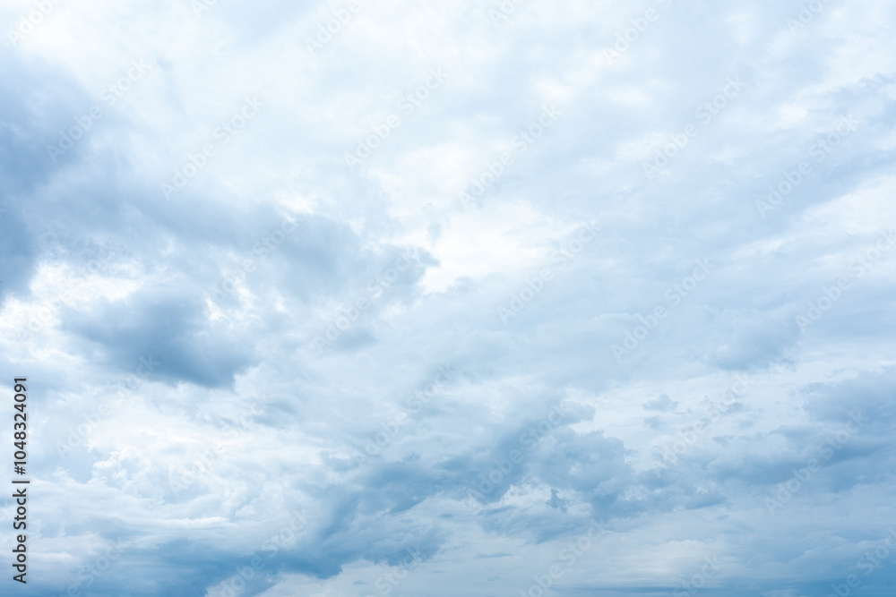 Naklejka premium Beautiful fluffy white clouds drift across a clear blue sky
