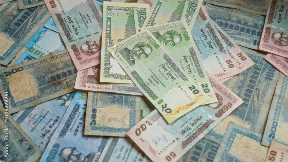Bangladeshi banknotes spread out showing various denominations of taka, highlighting the currency used in bangladesh with intricate designs and colors. Bangladeshi banknotes spread out showing various denominations of taka, highlighting the currency used in bangladesh with intricate designs and colors.