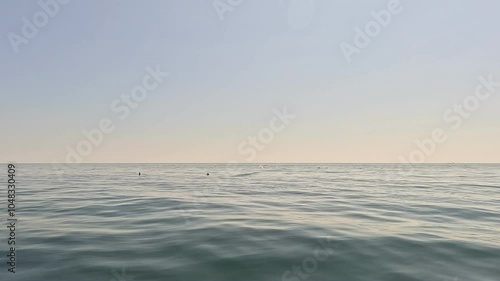 Sea Ocean Horizon - Calm Water Surface with a Hazy Skyline on a Cloudy Day.