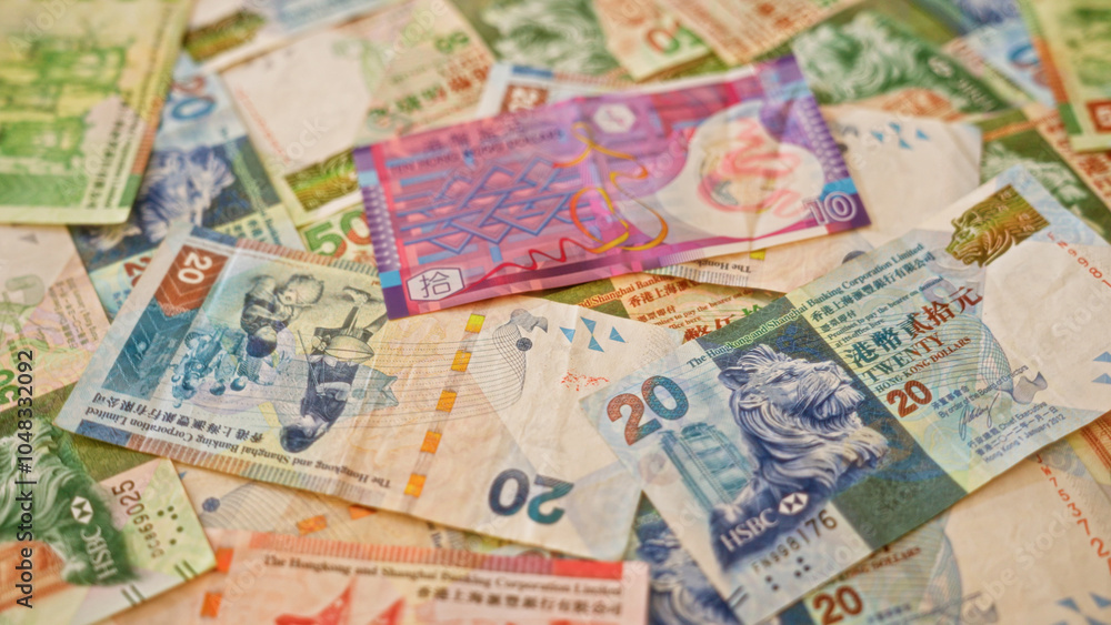 Colorful hong kong dollar banknotes in various denominations scattered across a surface showcasing vibrant currency design and financial elements Colorful hong kong dollar banknotes in various denominations scattered across a surface showcasing vibrant currency design and financial elements