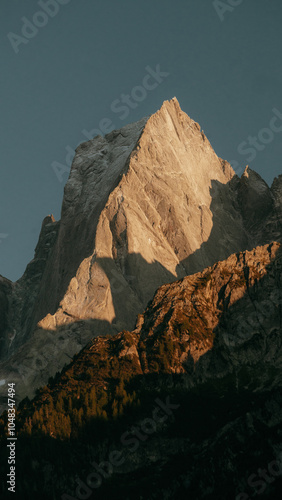 Obraz na płótnie Piz Badile mountain peak in the Swiss Alps in golden evening light at sunset, Val Bregaglia, province of Sondrio, Switzerland w salonie