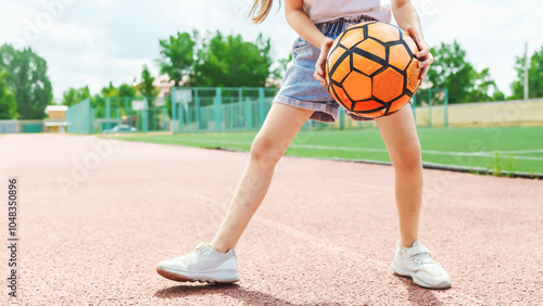 Close-up of a soccer ball in the hand of a female soccer player