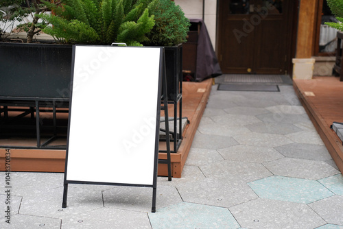 Obraz na płótnie Blank white outdoor advertising stand sandwich board mock up template. Clear street signage board placed by an outdoor dinning area of a restaurant. w salonie