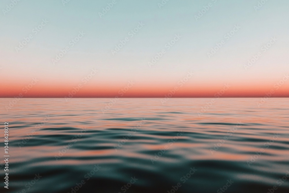 Fototapeta premium Calm ocean reflecting pink and orange sunset sky