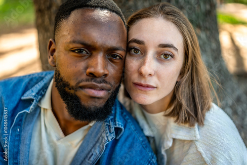 A multiracial couple together in a park