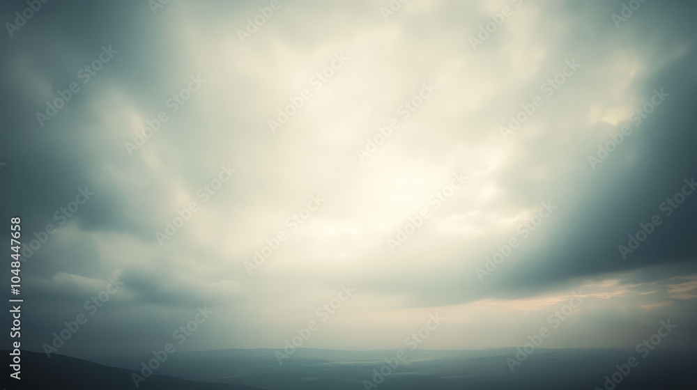 Obraz premium A thick hazy sky with light gray clouds obscuring the horizon, creating a moody, atmospheric scene as the light fades