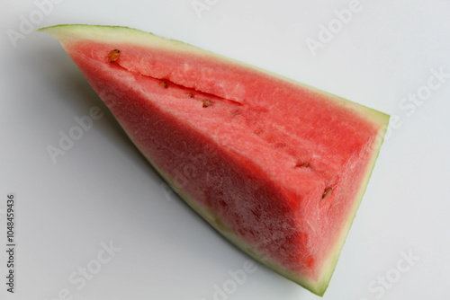 A piece cut of ripe red watermelon, isolated on white background, flat lay or top view photo