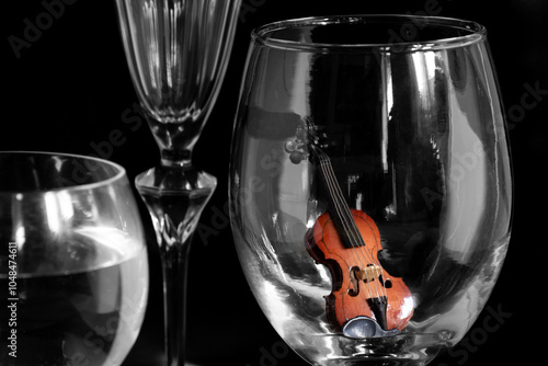 Miniature Violin still life on a wine glass