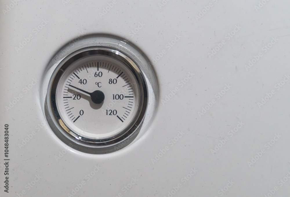 Round thermometer. Thermostat on a gas boiler Round thermometer. Thermostat on a gas boiler