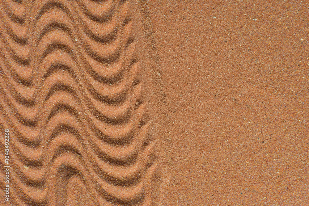 Lines drawn in brown sand background, beautiful sand texture, overhead view of chocolate brown sand, zen pattern drawn in the sand, Top view of fine grain texture Lines drawn in brown sand background, beautiful sand texture, overhead view of chocolate brown sand, zen pattern drawn in the sand, Top view of fine grain texture