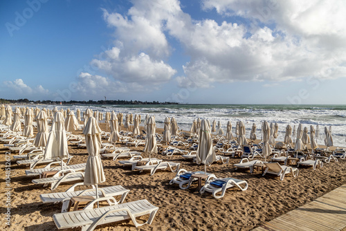 Fototapeta Naklejka Na Ścianę i Meble -  Beach chairs and umbrellas at the beach of Side, Antalya, Turkey. Before start of season 