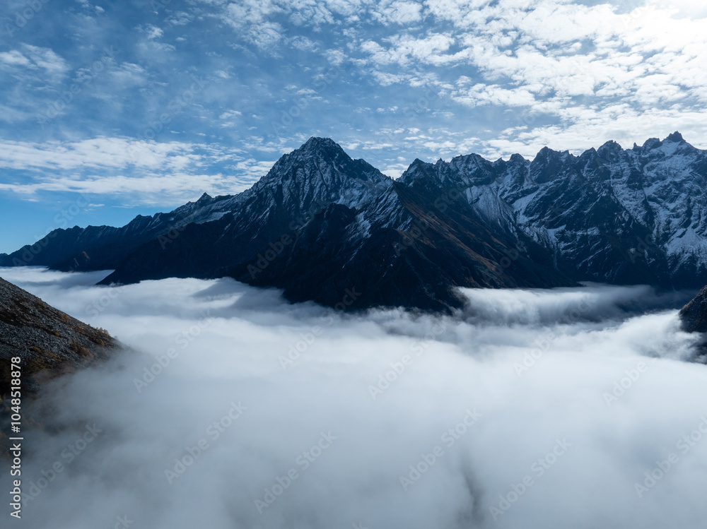 Obraz premium Aerial view of beautiful snow capped mountains and autumn forest landscape