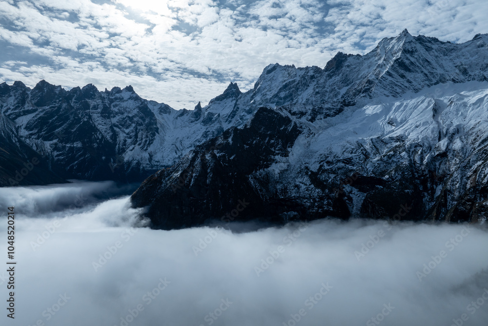 Fototapeta premium Aerial view of beautiful snow capped mountains landscape