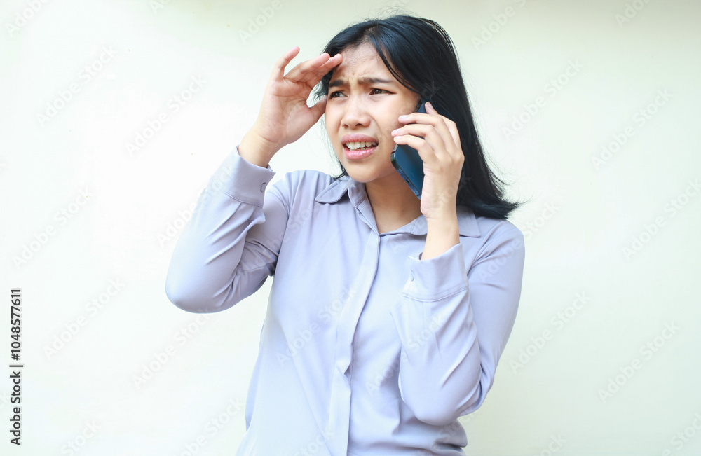 portrait of confused asian young business woman look away worried while having conversation on smartphone, isolated over white background female touch her forehead portrait of confused asian young business woman look away worried while having conversation on smartphone, isolated over white background female touch her forehead