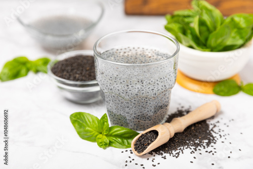 Basil seeds on textured wooden background. Close-up. Superfood. Ocimum basilicum. Organic basil seeds. selasih. Space for text. Copy space. photo