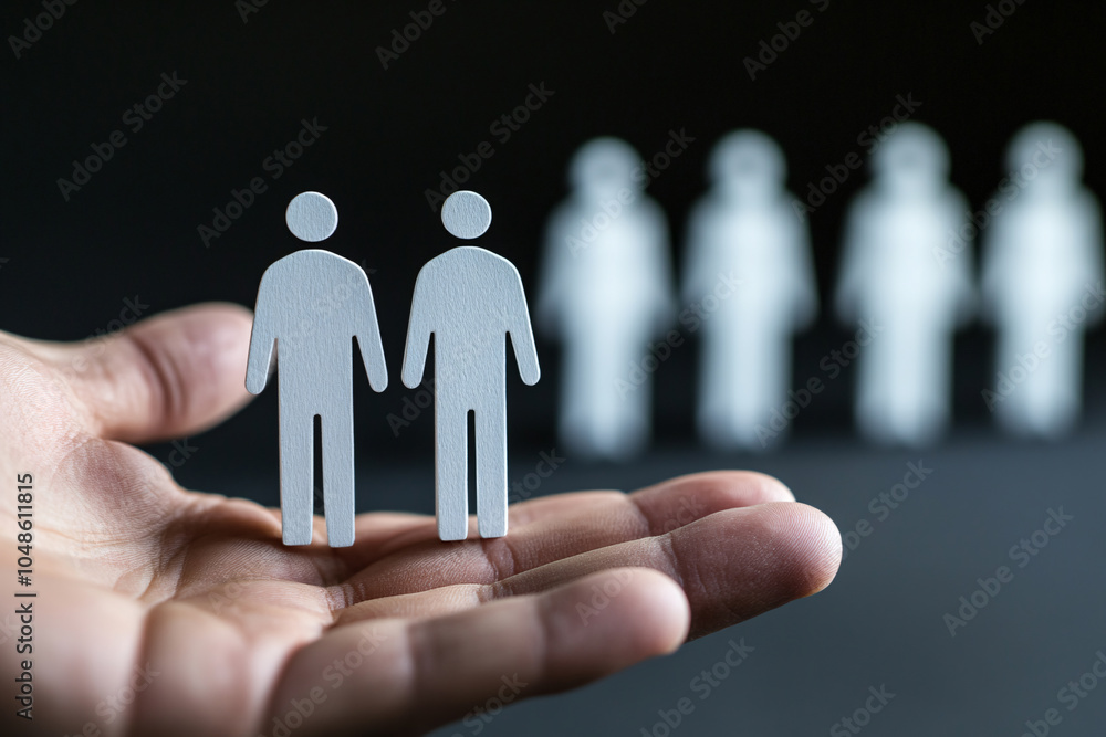 Choice and Equality: Wooden Figures on a Hand Choice and Equality: Wooden Figures on a Hand